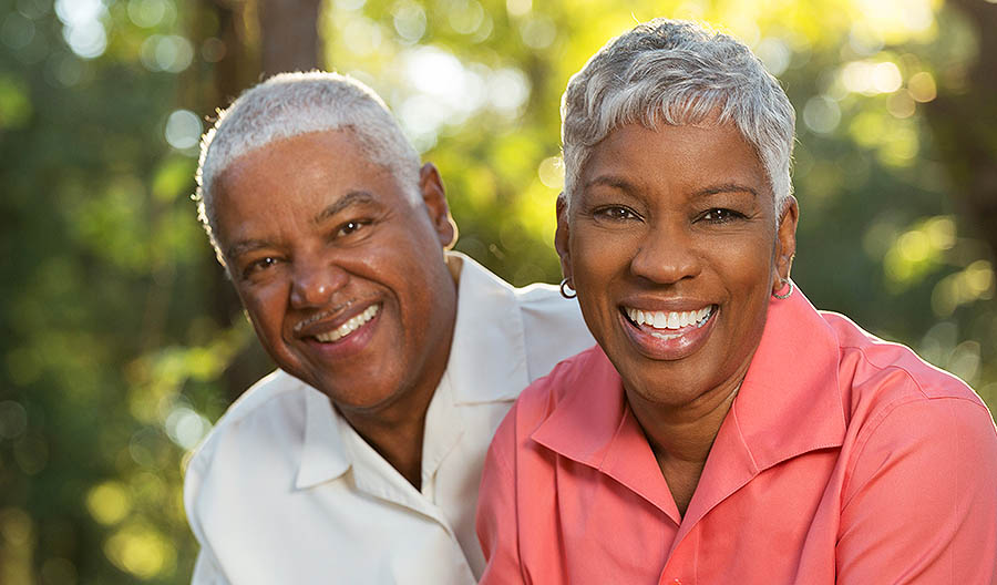 Smiling couple after their dental restoration procedures here in Los Angeles.